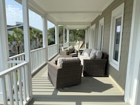 Another section of the porch on the second floor. So many comfy options!