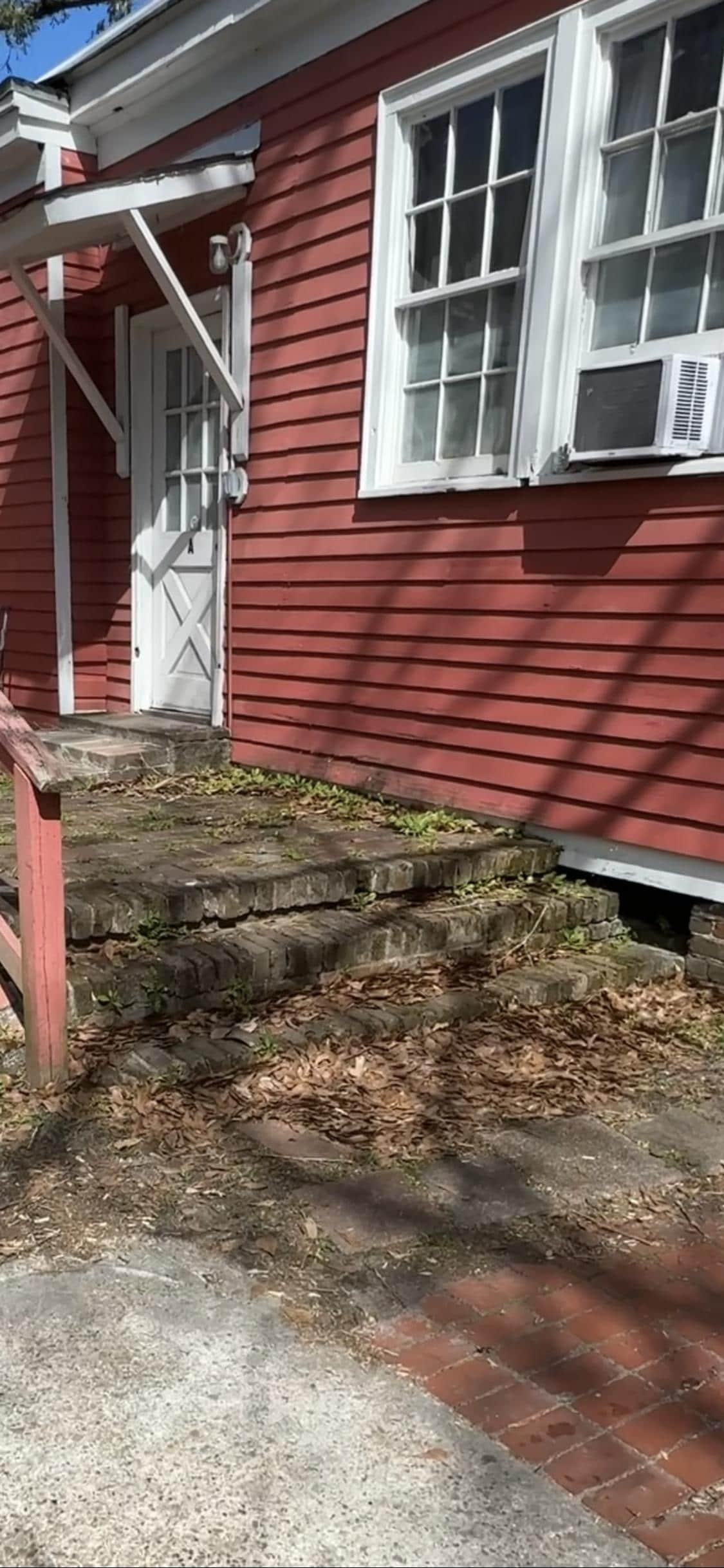 Back of home with painted out windows because of dangerous neighborhood. 