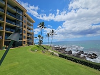 Grab shade under the palm trees on this manicured lawn. Unit is shown here, 2nd floor, far right.