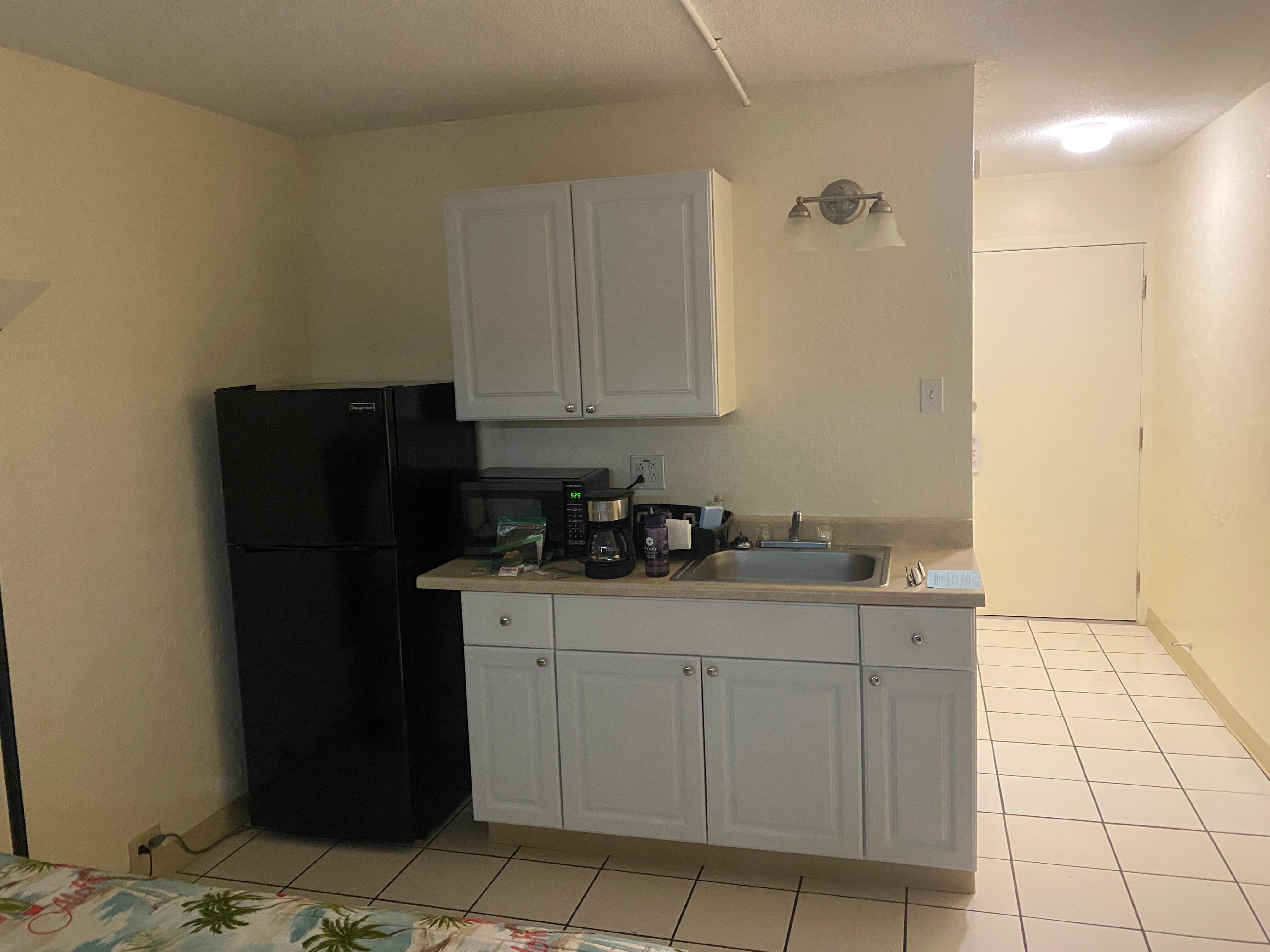 Kitchen fridge microwave crockery utensils and electric Frying pan sink 