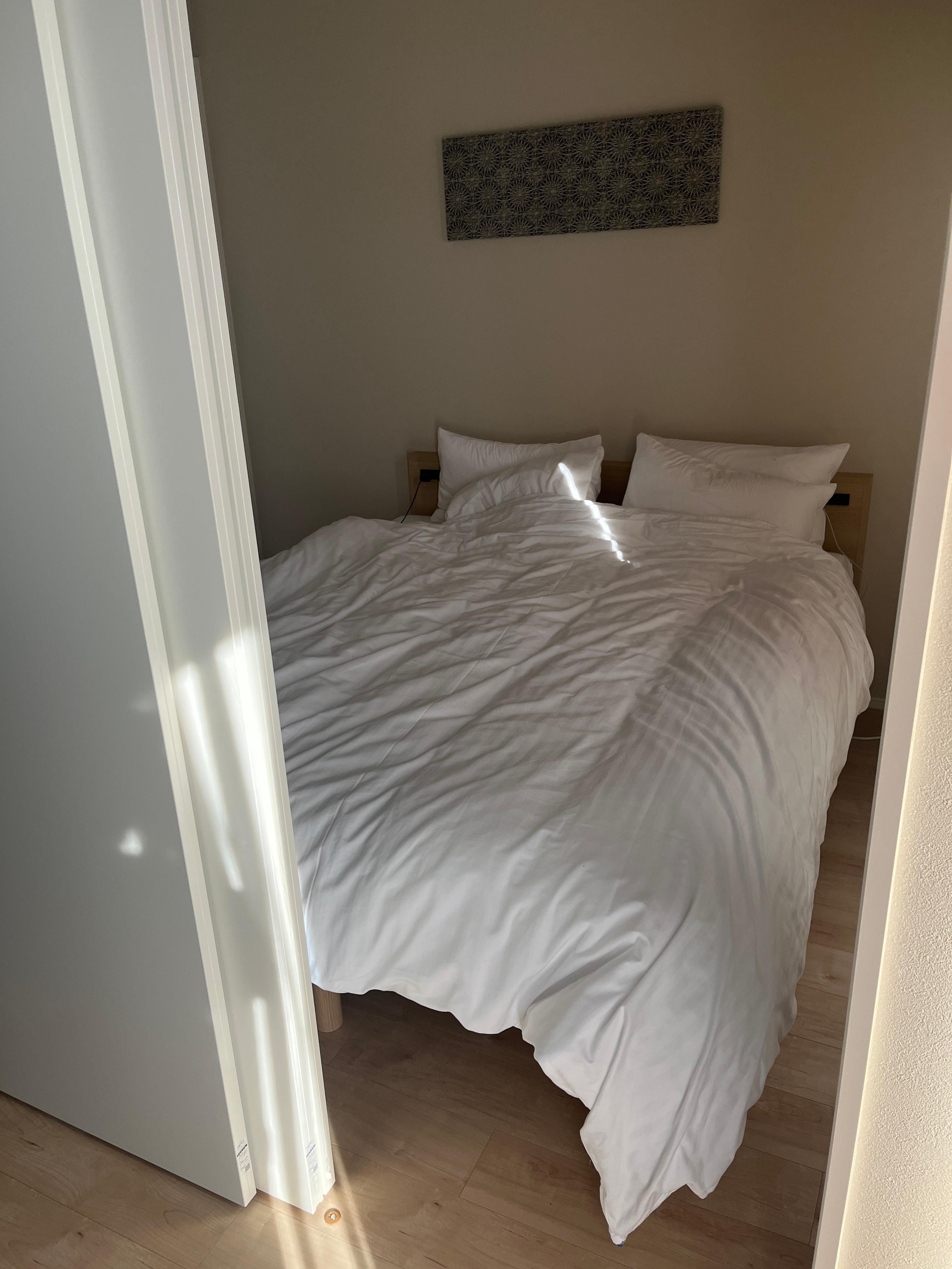 One of the bedrooms across from the kitchen with a queen bed and closet. The doors are on tracks so you can have them opened or closed