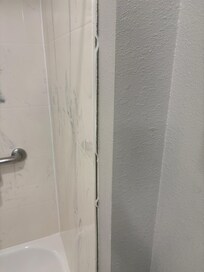 Fake tile separating from wall
