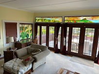 Living room and back doors to the deck with beautiful stained glass.