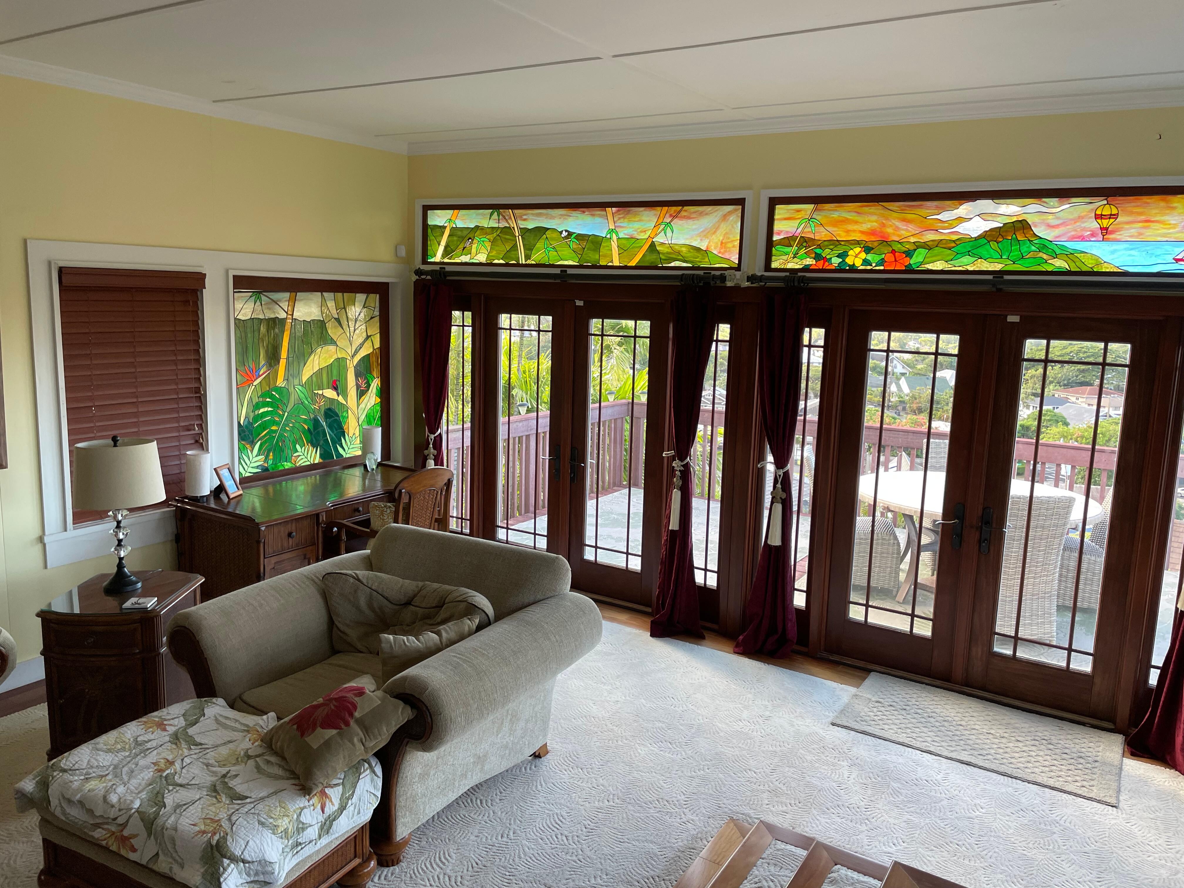 Living room and back doors to the deck with beautiful stained glass.