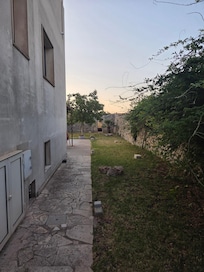 Side walkway to the pool from the modern side of the house