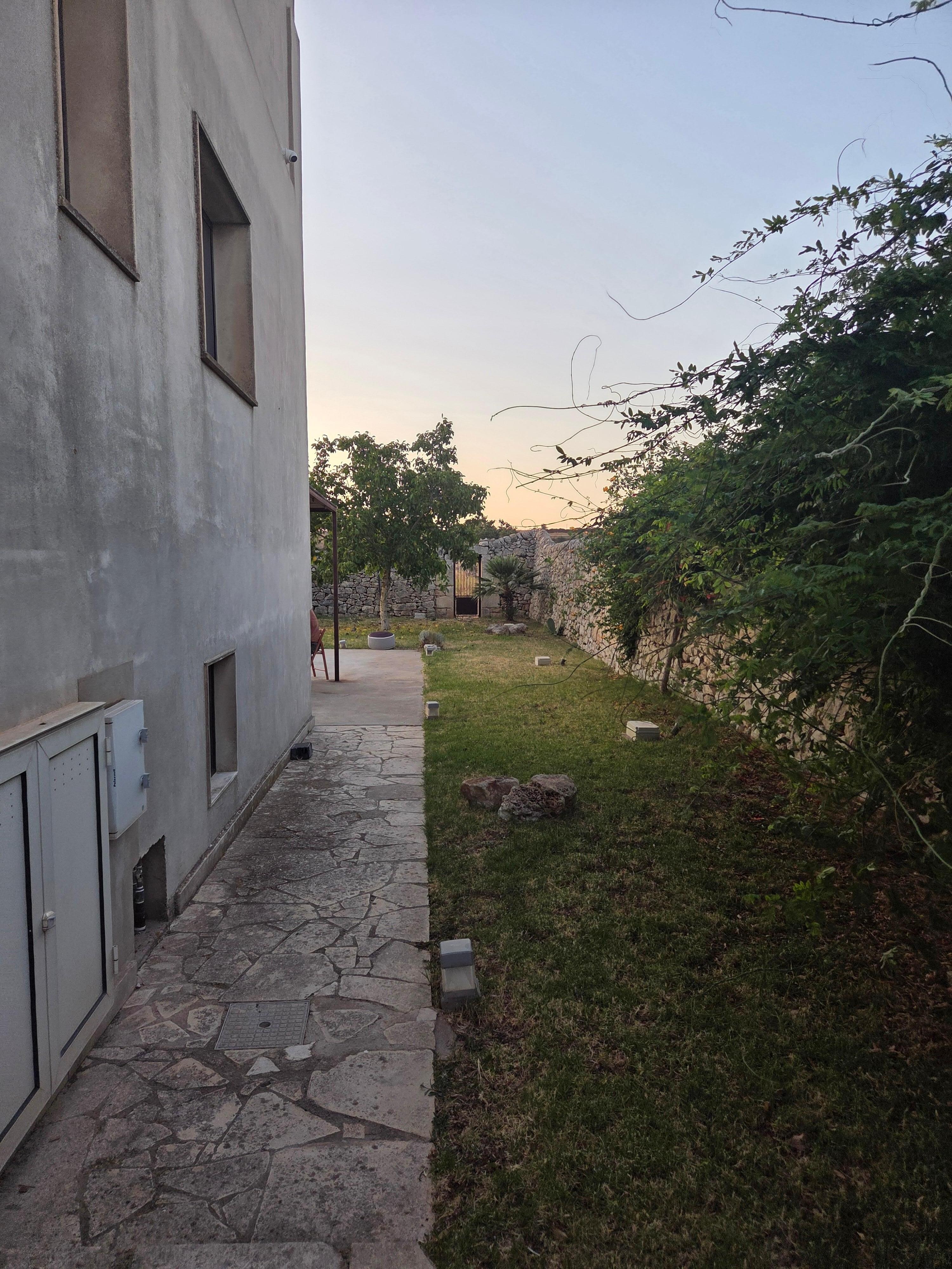 Side walkway to the pool from the modern side of the house