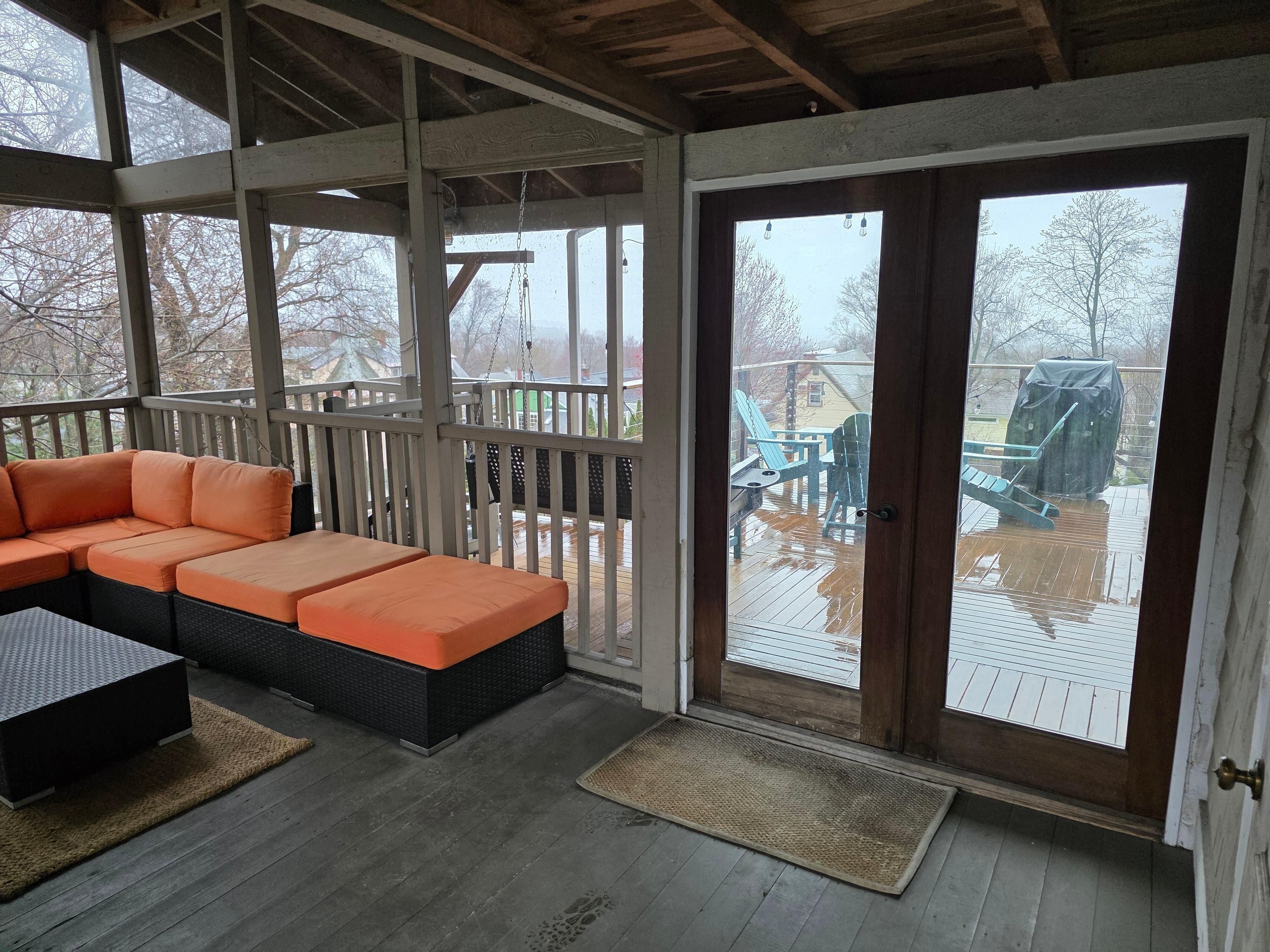 View of the screened in porch towards the fire pit. 