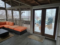 View of the screened in porch towards the fire pit.
