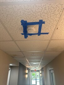 covered smoke detector by elevator