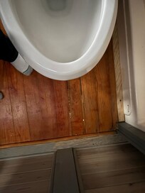 Bathroom floor in front of toilet. You could literally see through the floor to under the cabin