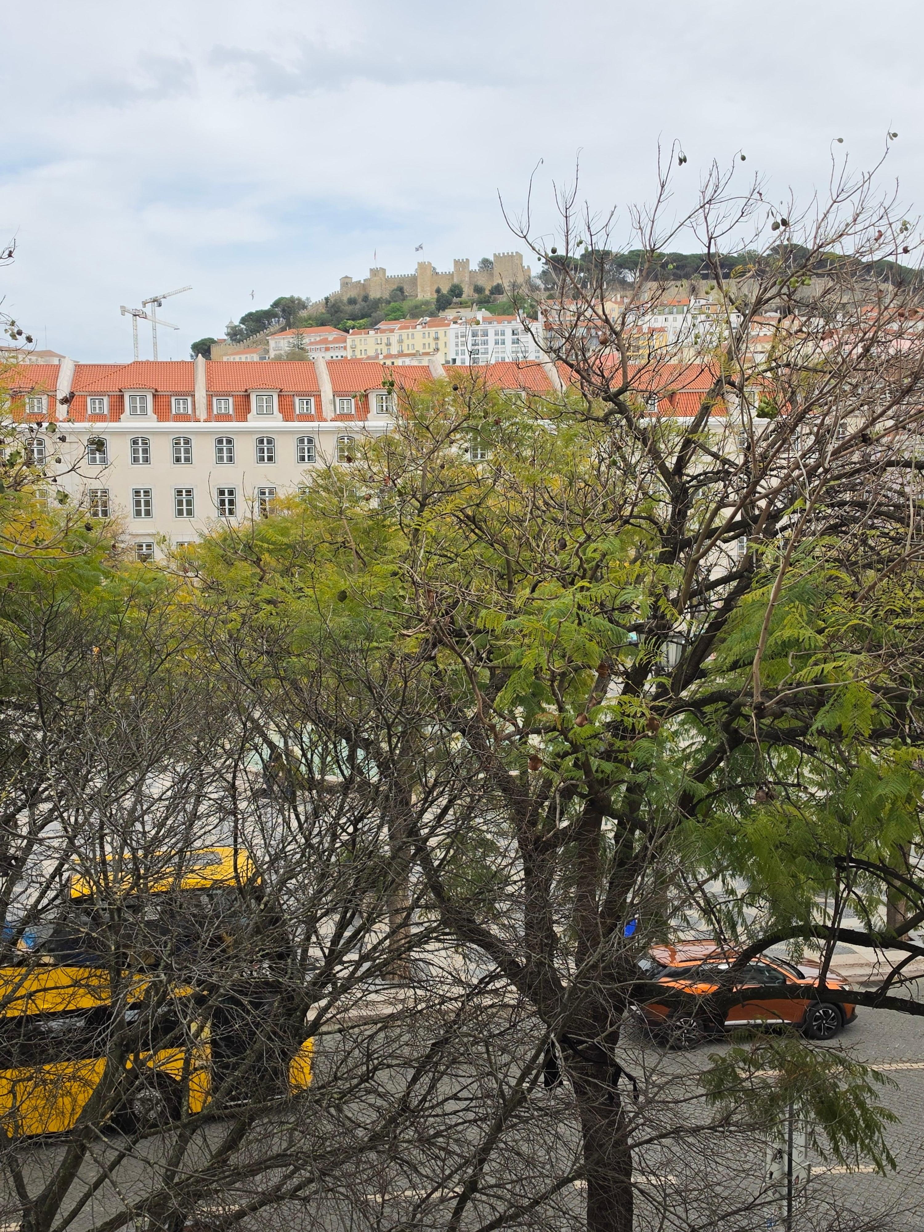 View of square from room with castle in background.