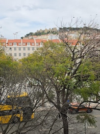 View of square from room with castle in background.