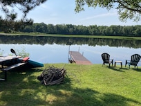 View from the Cabin #2 of the pier, picnic table, chairs and the flowage,