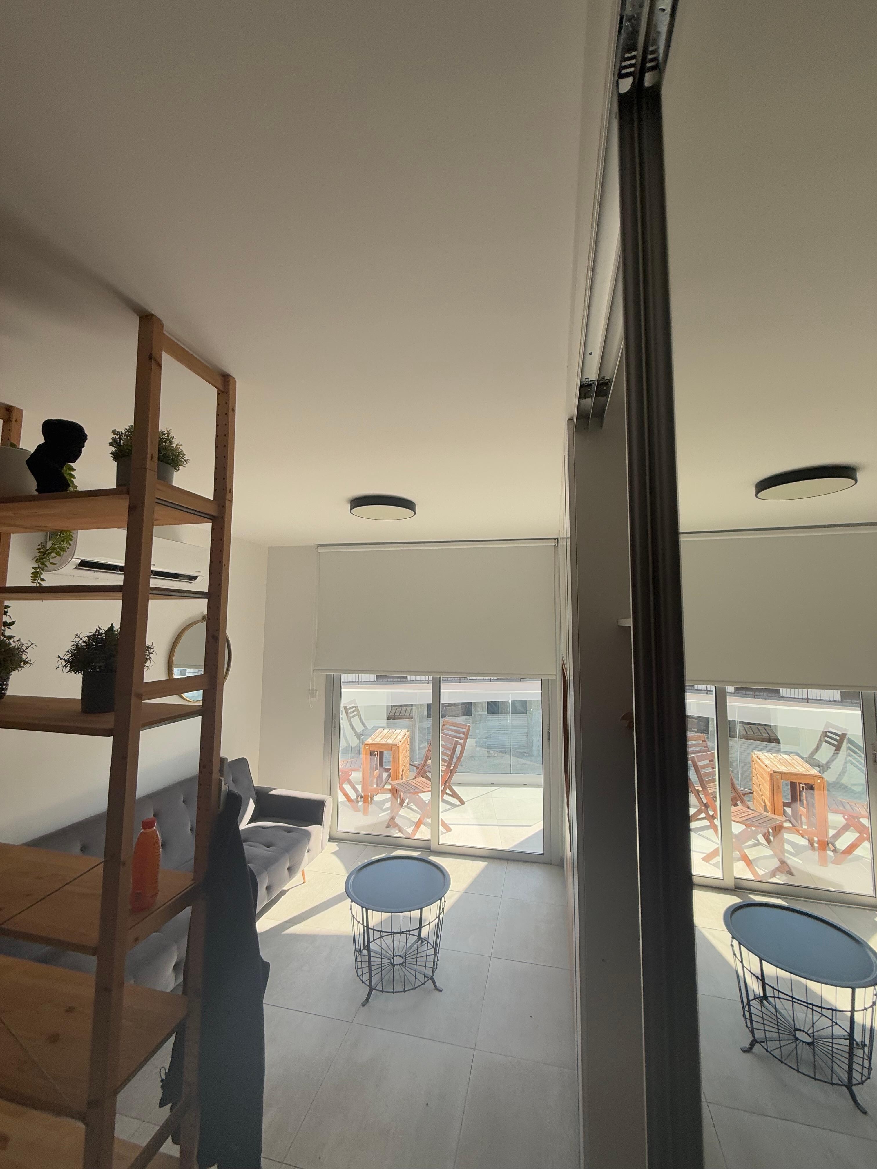 Kitchen into bed and sofa area (plus balcony to sit outside)