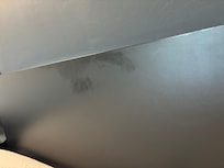 Oily stain on headboard not cleaned after second cleaning