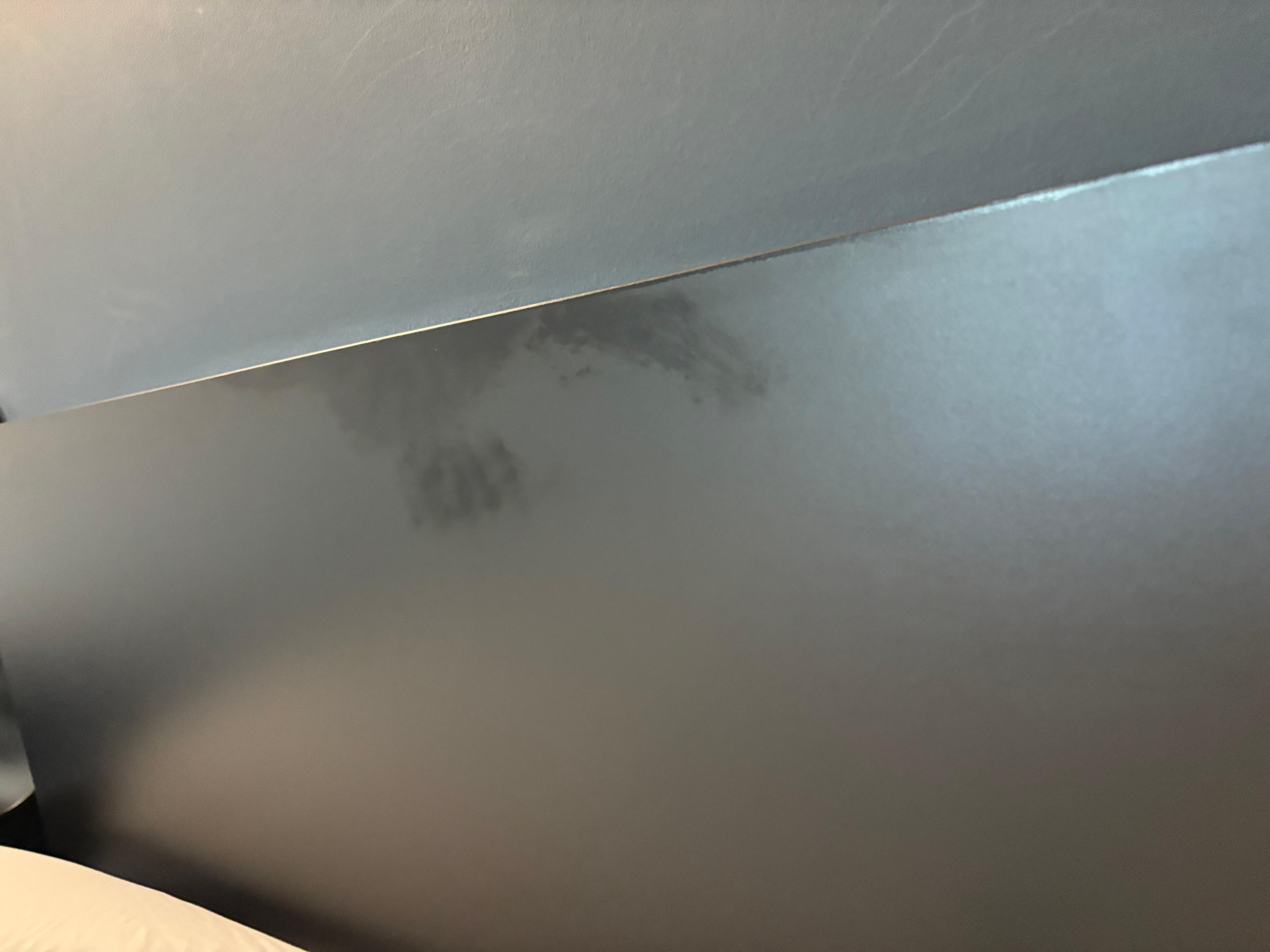Oily stain on headboard not cleaned after second cleaning 
