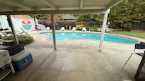 Great back patio area with pool and hot tub, fire table that actual emits heat and comfy lighting