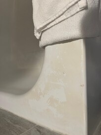 Outdated tub with soap scum that could easily be removed