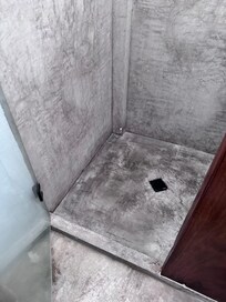 Scary looking concrete shower.