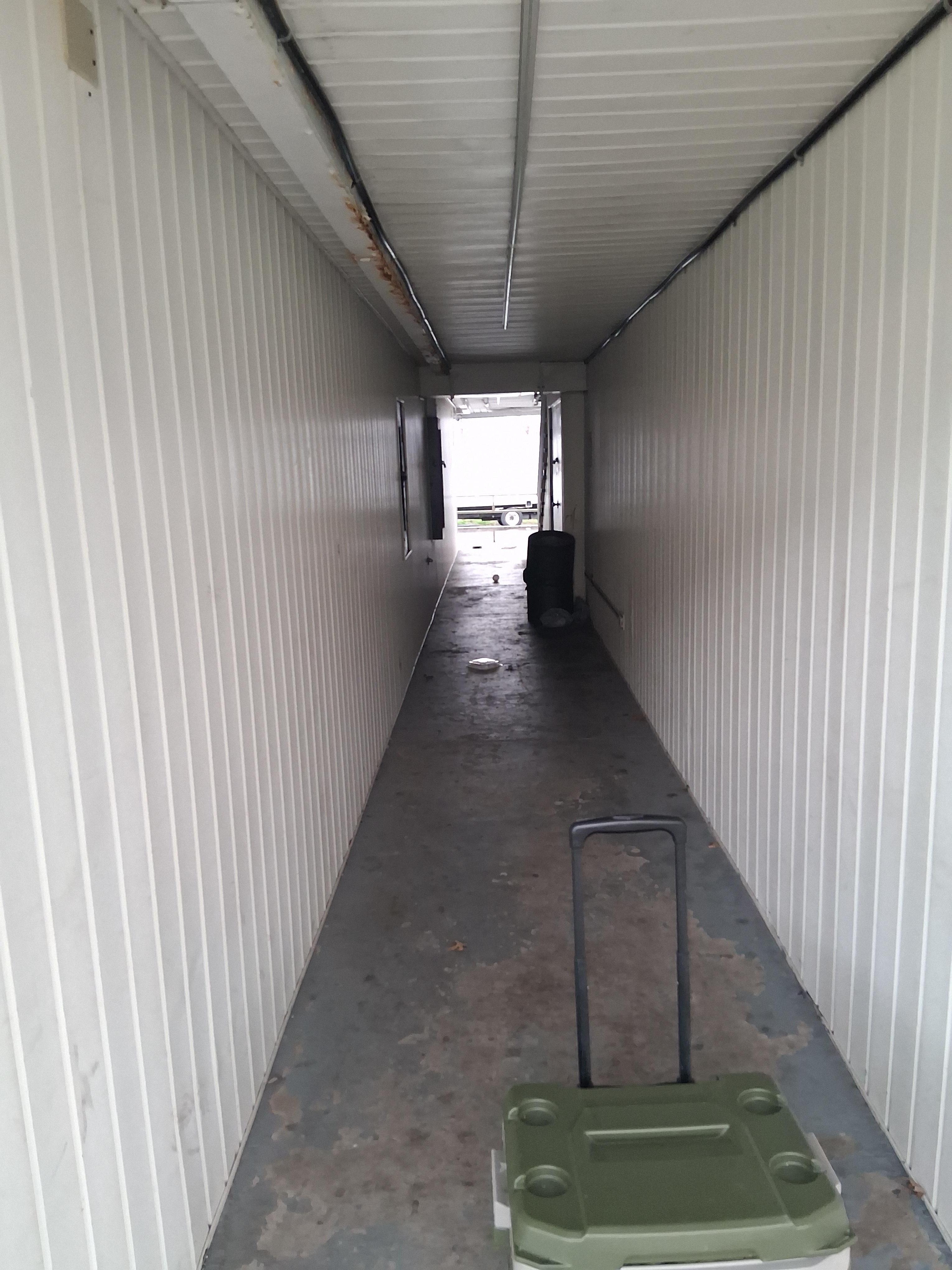 Tunnel between front and back, full of loose trash.