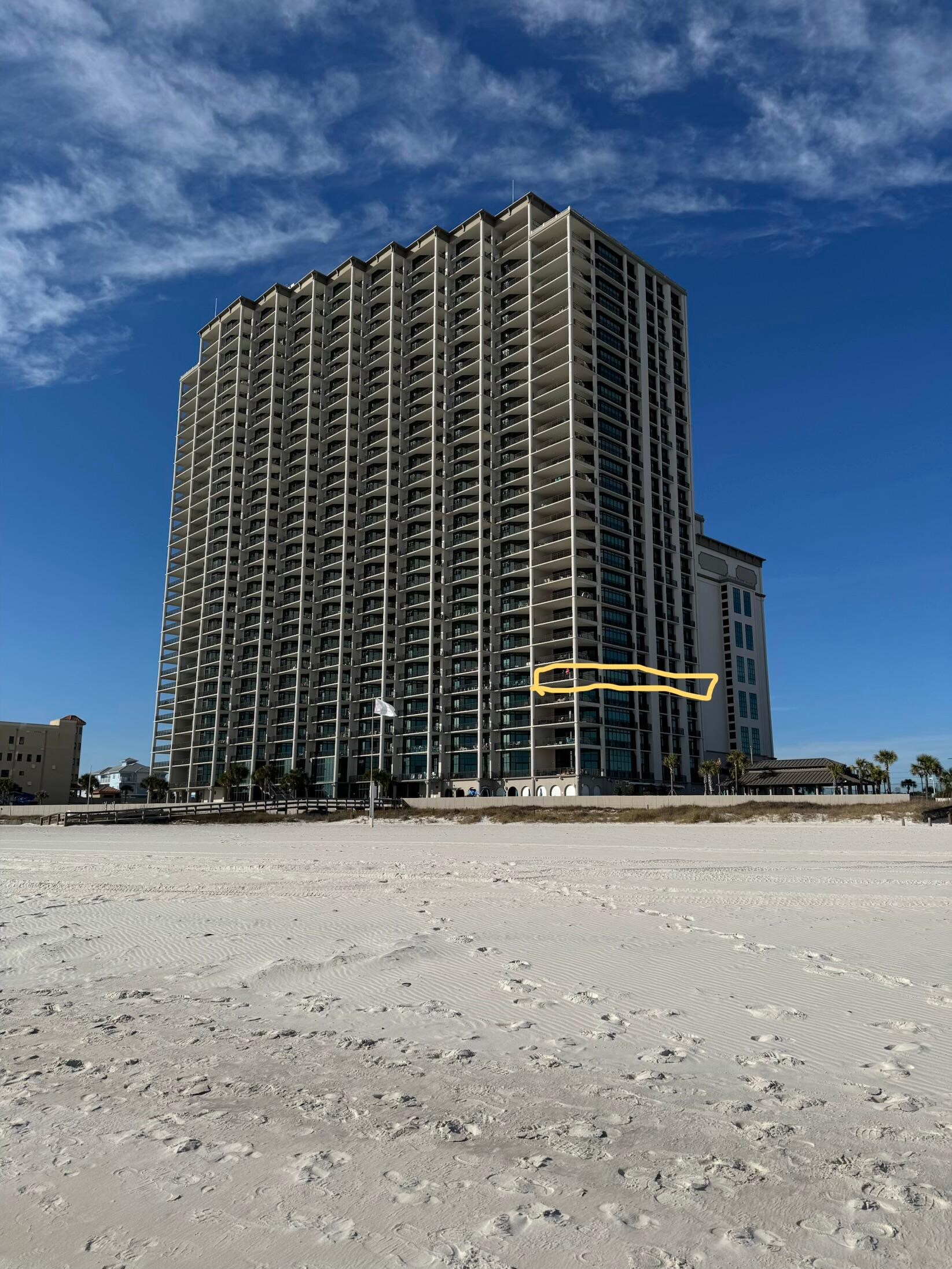 View of building from beach. Condo is highlighted.