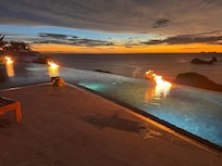 Infinity pool fires at sunset