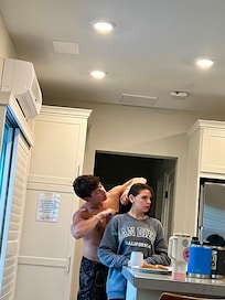 My oldest son combing his girlfriend’s hair in the kitchen area (nice open kitchen) just returned from a day in the beach.