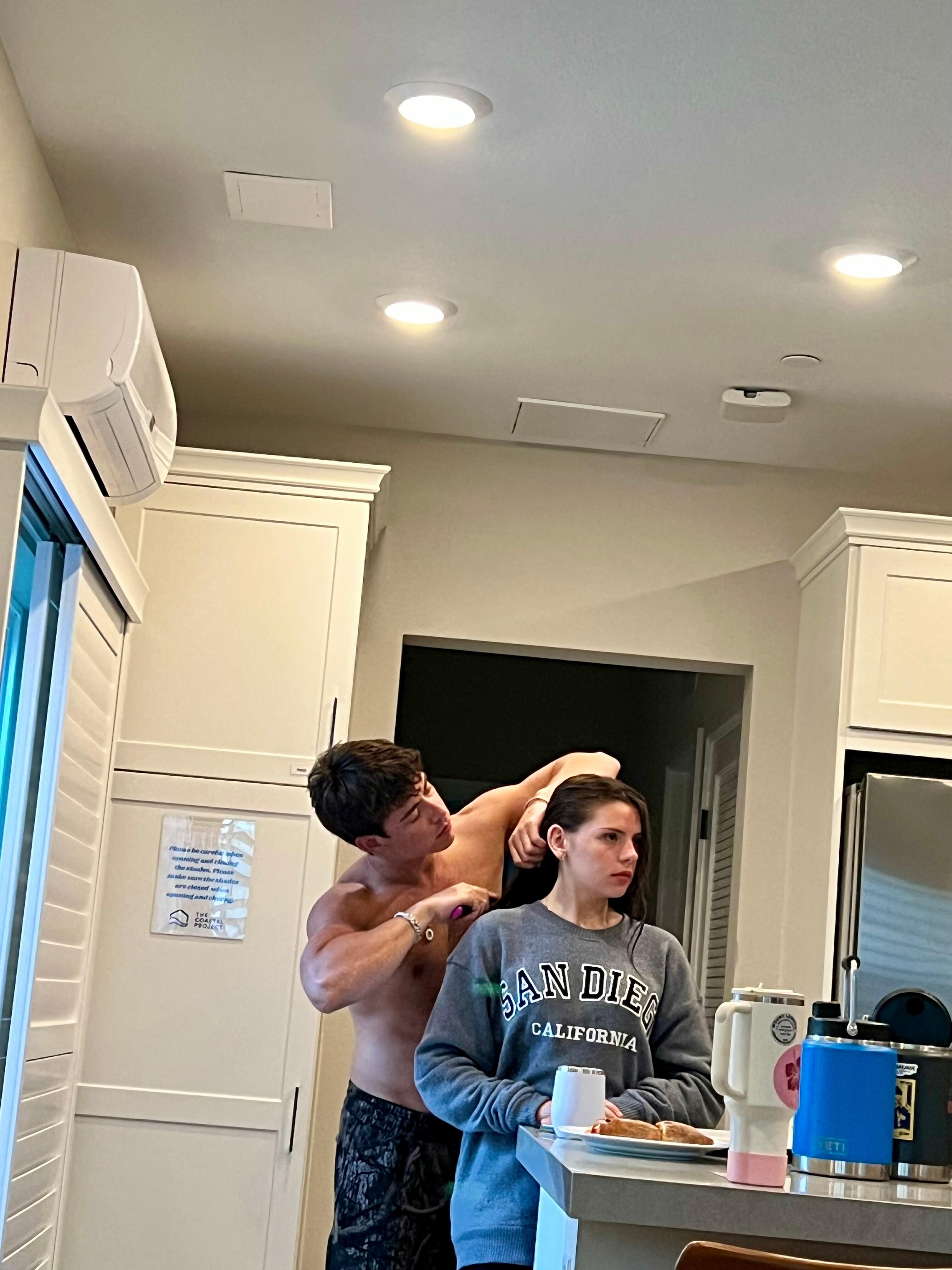 My oldest son combing his girlfriend’s hair in the kitchen area (nice open kitchen) just returned from a day in the beach. 