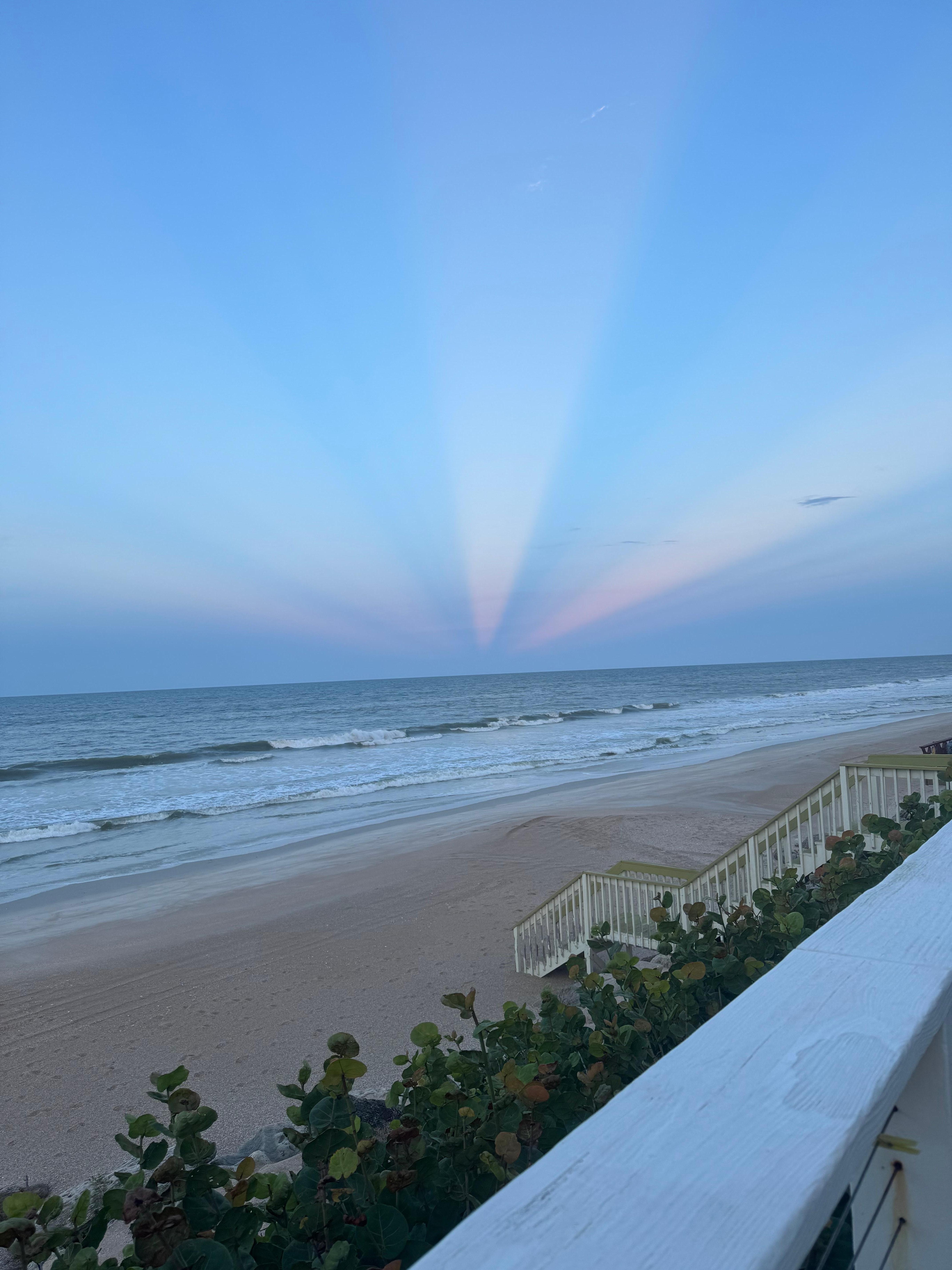 Kaleidoscope sunbeams cast through the clouds from the beautiful sunset