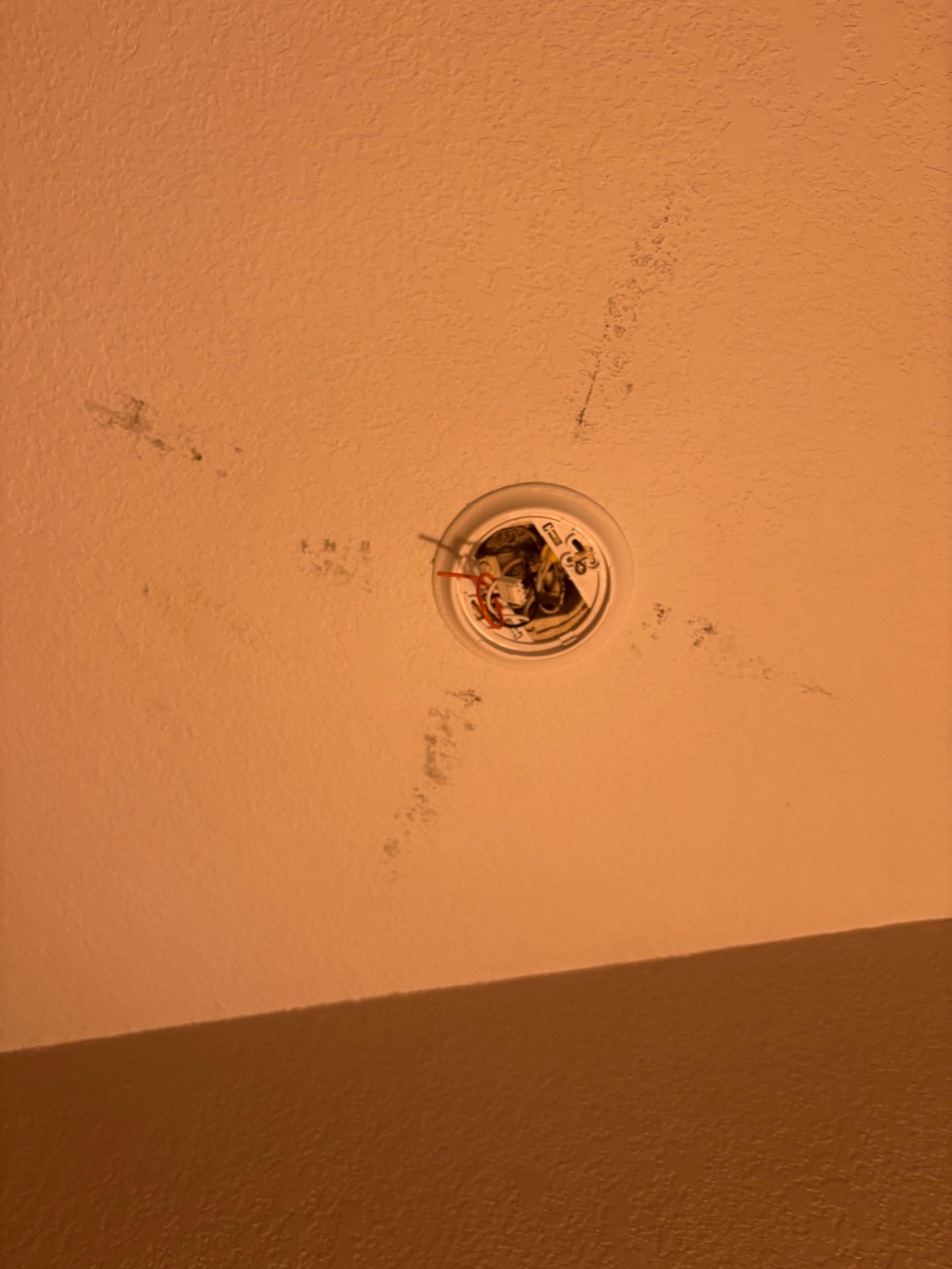 Smoke detector removed and never replaced leaving exposed wires 