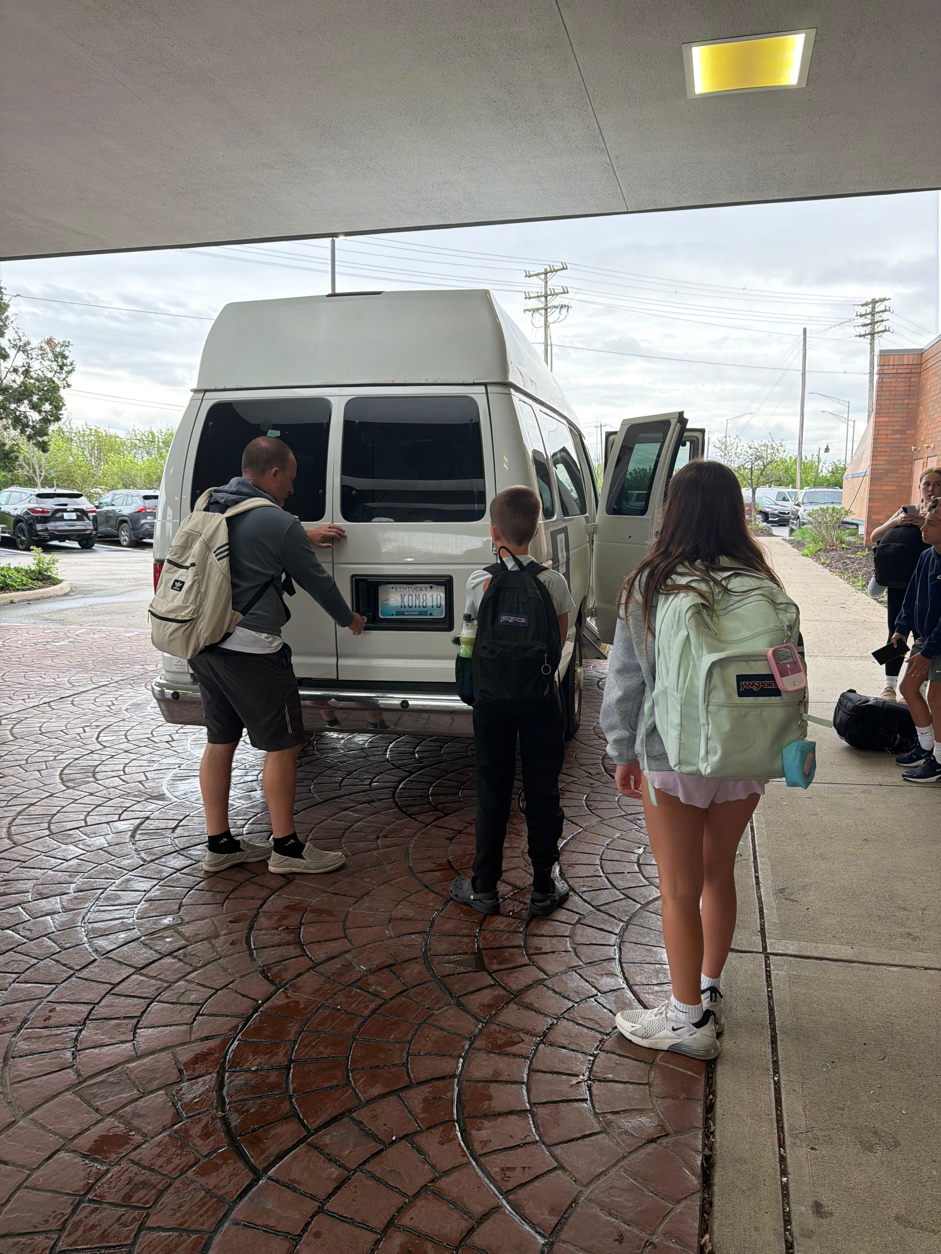 Travelers trying to help get the back door open.