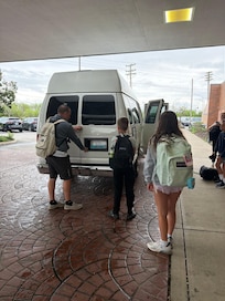 Travelers trying to help get the back door open.