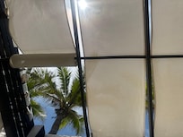 Cabanas are in disrepair. The fabric panels meant to provide shade are fastened with nails that have rusted from humidity. Wind easily knocks the panels loose, leaving fabric flapping dangerously with rusty nails attached. One cabana frame collapsed.