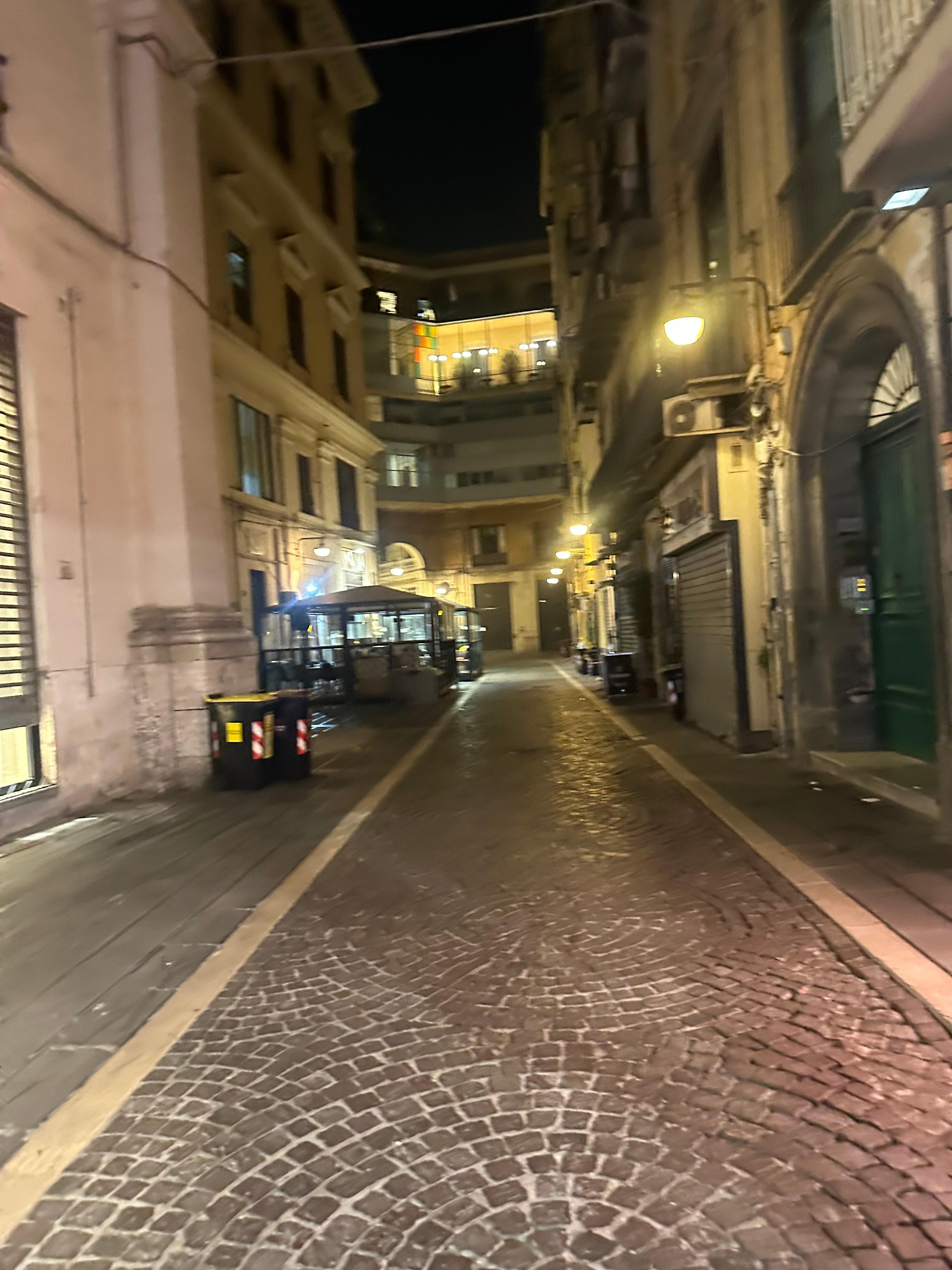 Hotel entrance at the end of street on the left