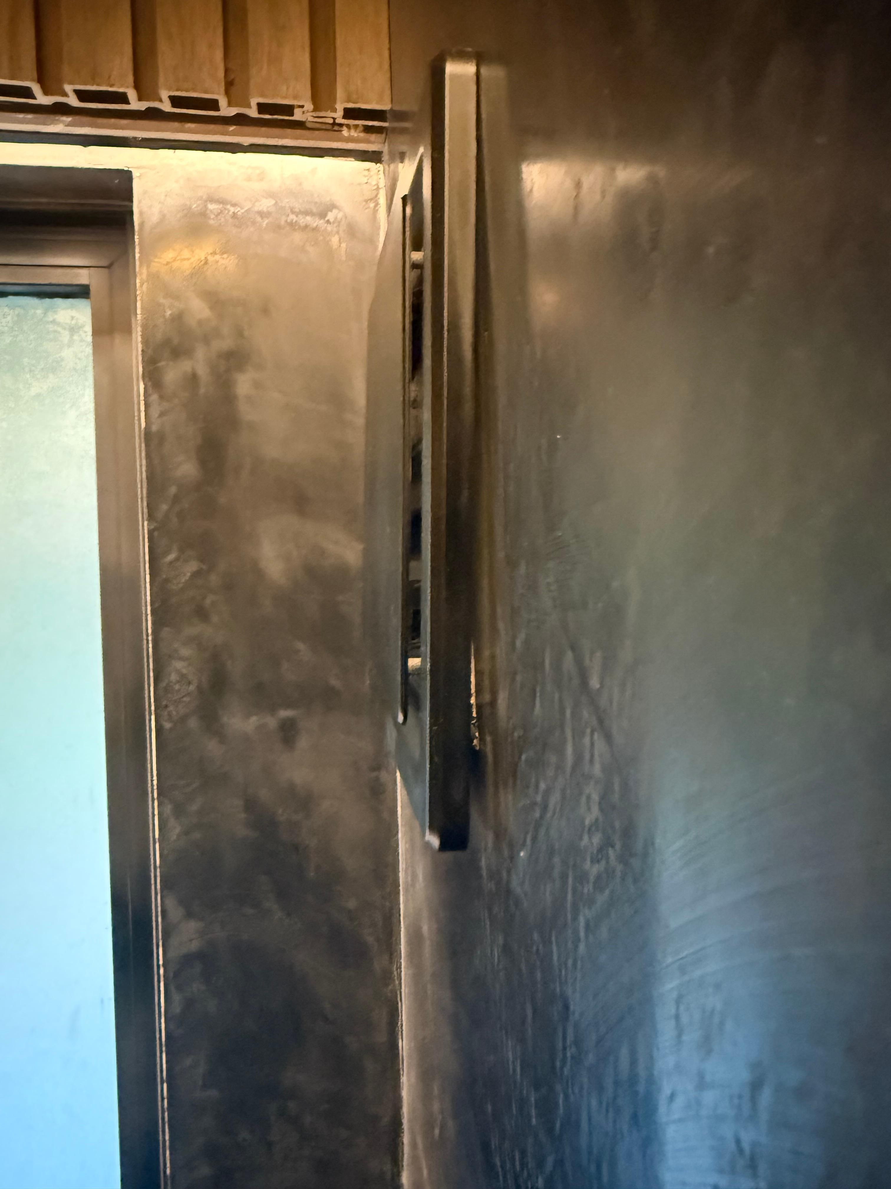 Bathroom fan not fully attached to wall 