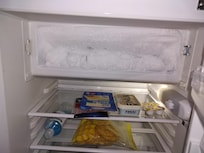 Freezer full of ice, not usable. Refrigerator door does not close properly: not cold + water from freezer