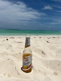 On the beach with an ice cold Kalik from the bar!