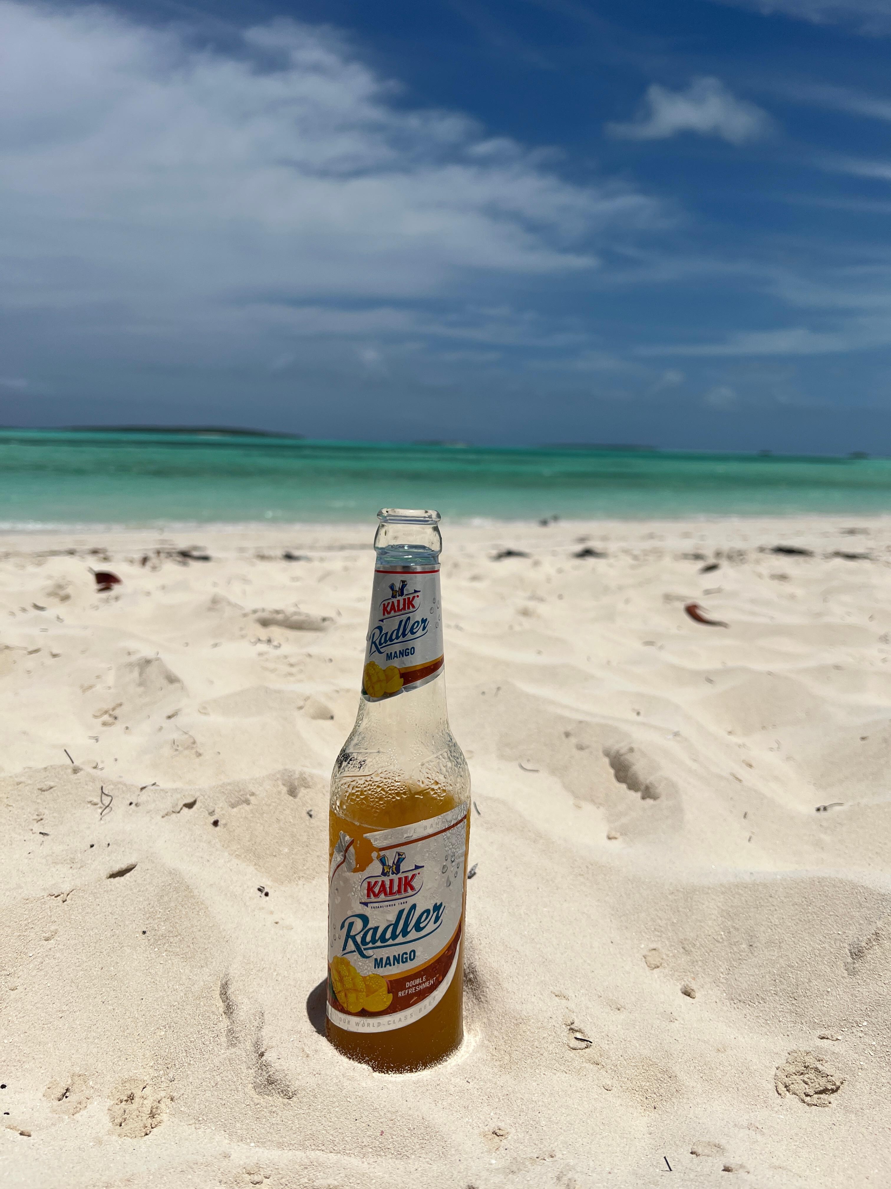 On the beach with an ice cold Kalik from the bar! 