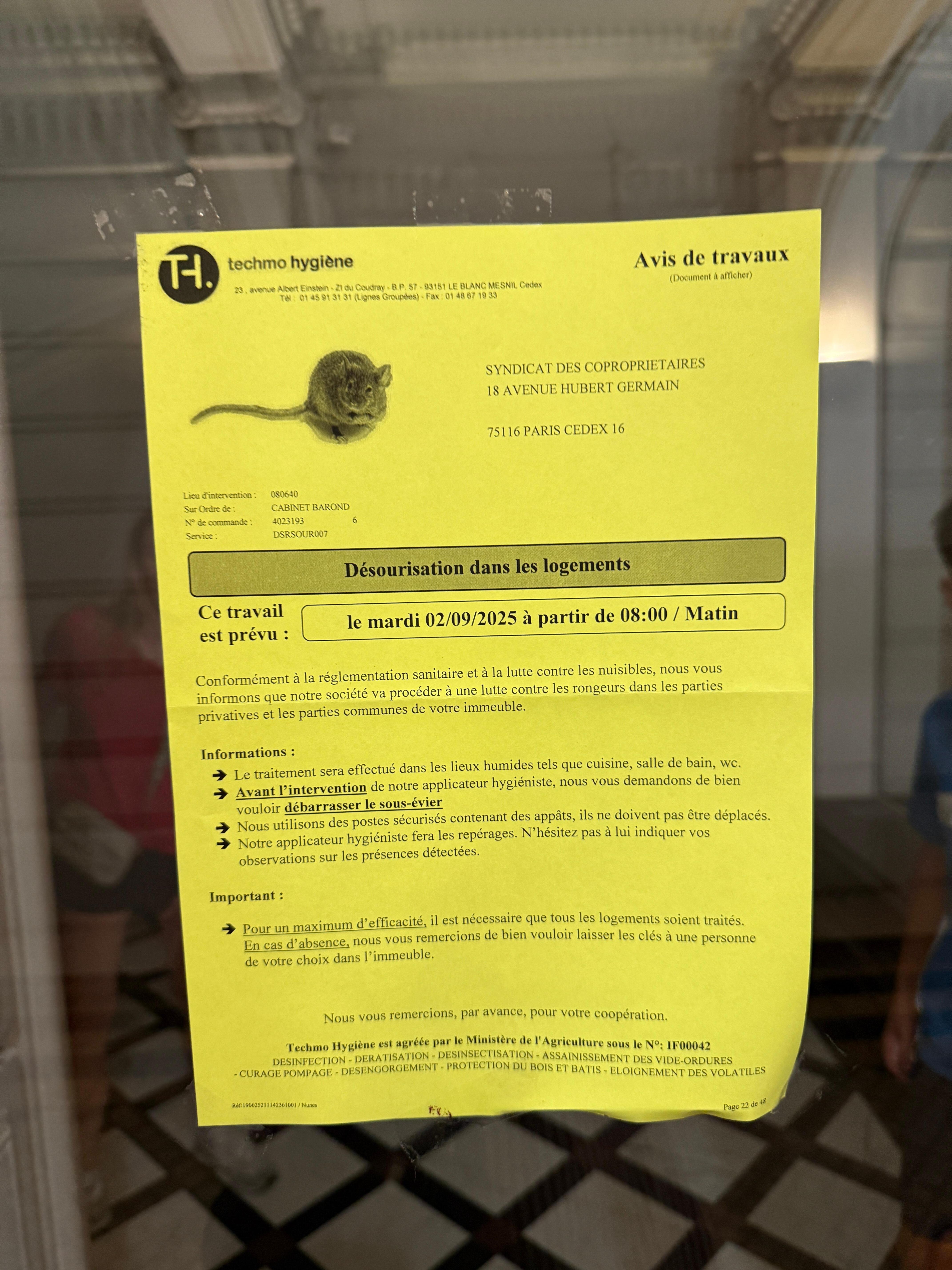Rodent service notice on front door of apartment building. Thankfully no evidence of mice while we stayed there. 