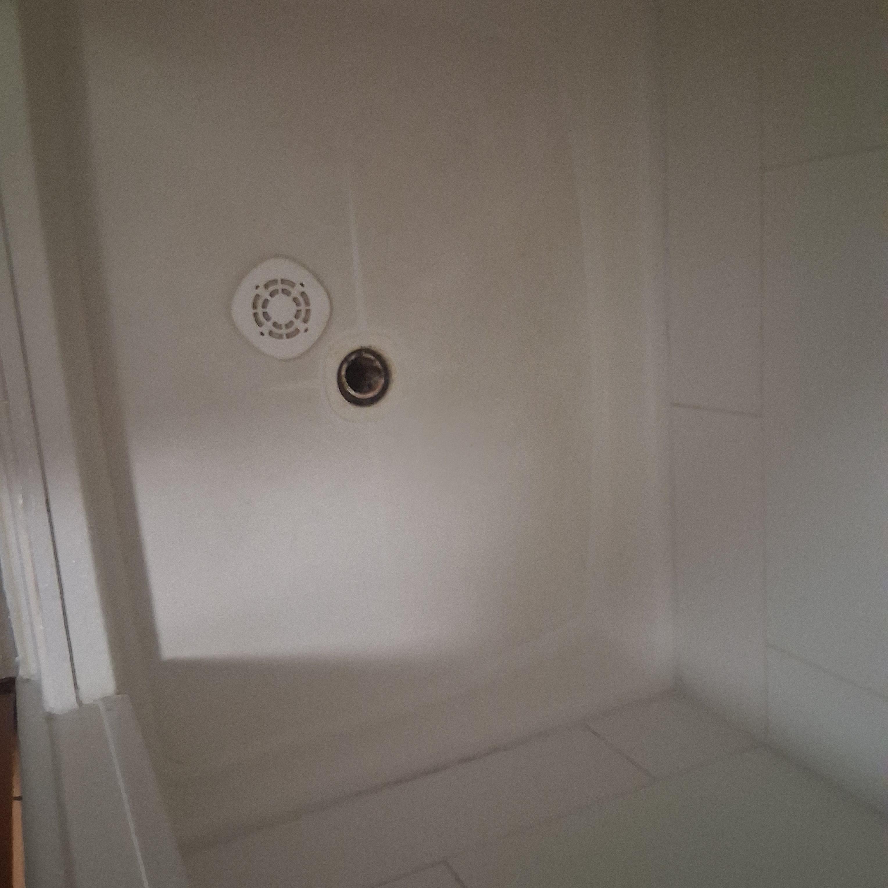 Shower drain cover not attached.