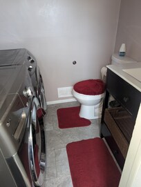 The bathroom had little clearance between the toilet and front load washer/dryer.