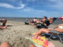 The family hanging out on a beautiful beach day