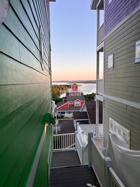 The front door is down a walkway and in the back