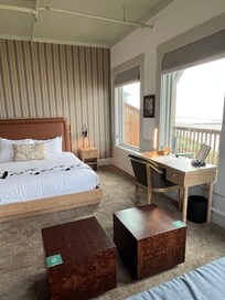 Room showing bed, nightstand, and desk.