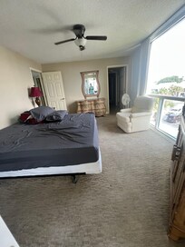 Primary Bedroom with a King bed (I apologize for the unmade bed we were cleaning up to go home) NOTE: no beach view - best beach view is 3rd bedroom - 2nd bedroom has a small beach view also.