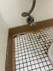Behind toilet
