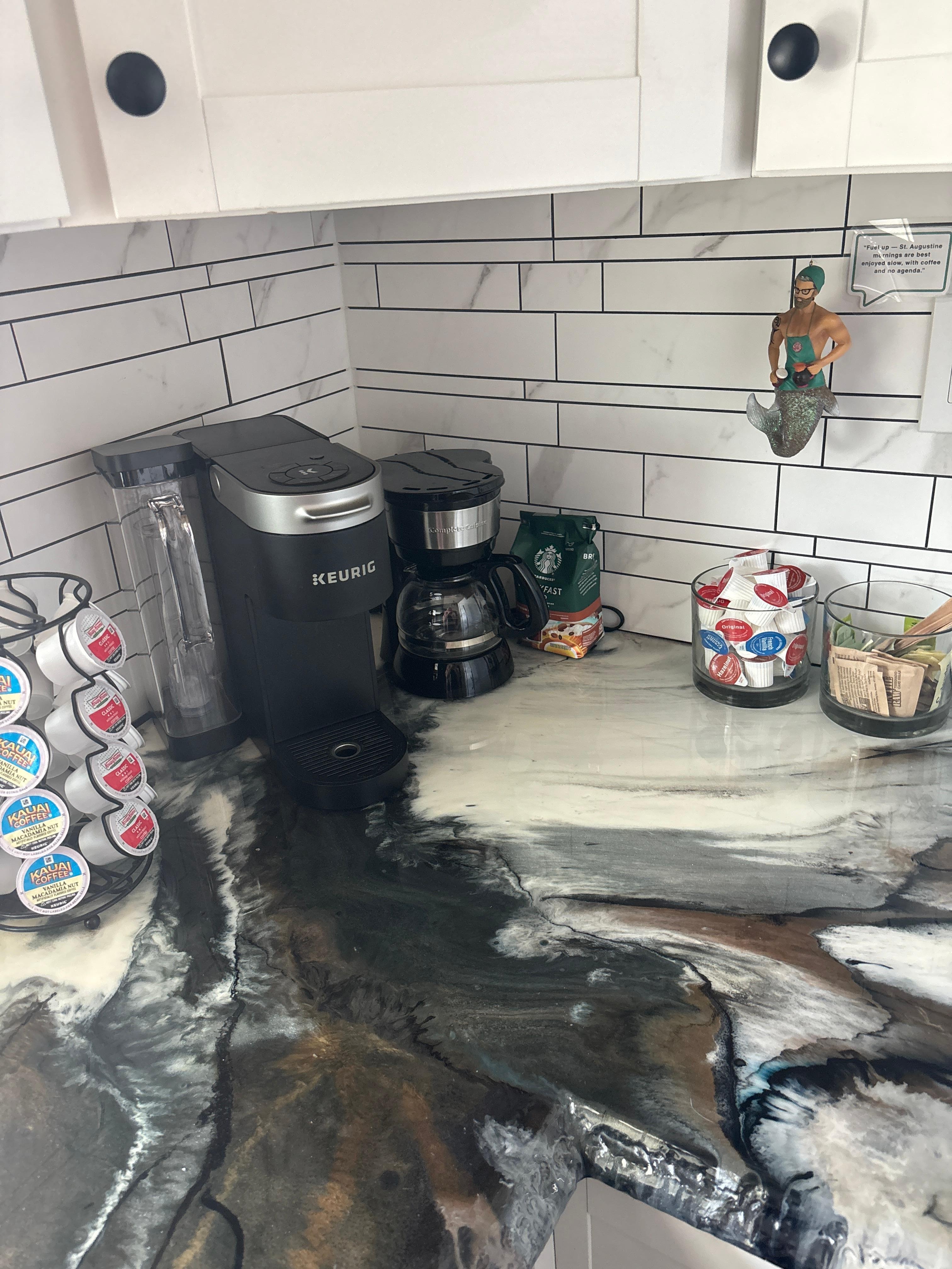 Kitchen with k-cups, coffee, creamers and tea