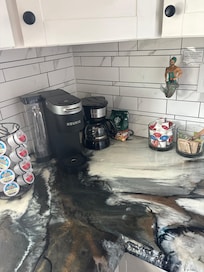 Kitchen with k-cups, coffee, creamers and tea