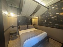 Only the bed area not showing the desk, coffee nook and rest of the room.