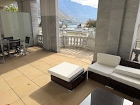 Balcony with table and chairs as well as a lounging area.